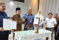 Bupati Tojo Una-Una Ilham Lawidu, S.H, dan Direktur GIWEH, Dr.Nidal Salim, saat melakukan penandatanganan MoU diruang rapat Kantor Bupati setempat, Jumat 2 Mei 2025